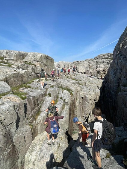 A group of hikers ascending a rocky mountain trail. 3
