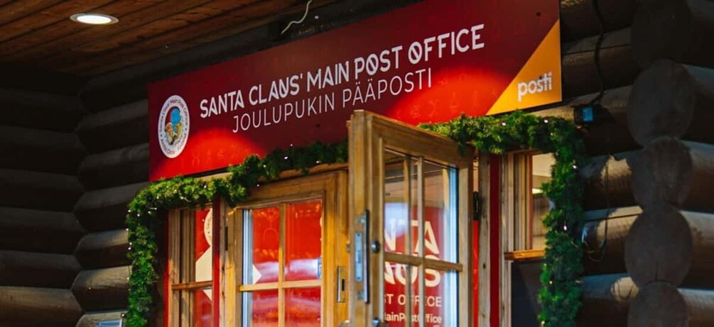 A Santa Claus Main Post Office with a red sign and a wooden entrance. 3
