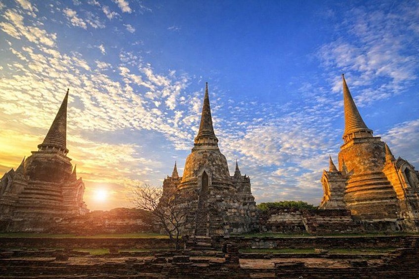 Ancient temple structures with pointed spires, set against a sunset sky. 2