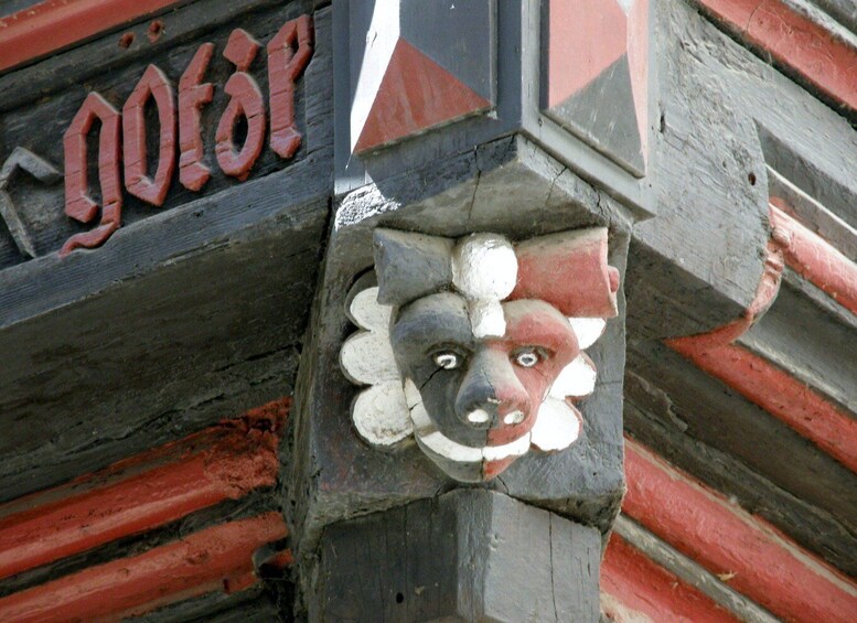 A carved wooden structure with a lion's face and the word 'goat' painted on it. 3
