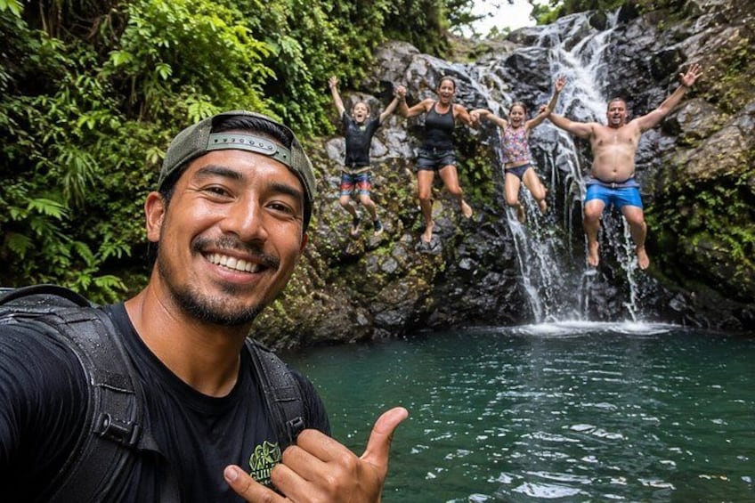 A waterfall with people jumping into the water. 1