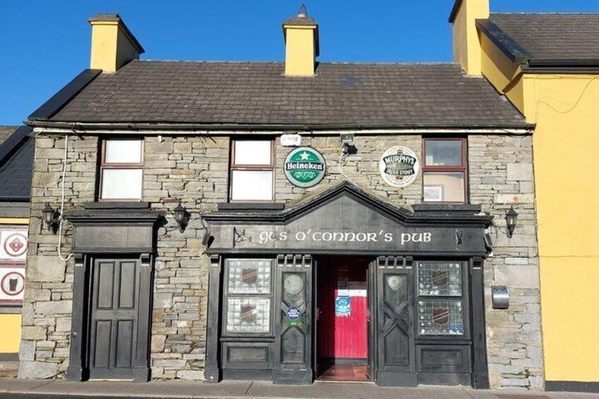 A stone building with 'G's O'Connor's Pub' signage, Heineken and Murphy's logos, and a red door. 5