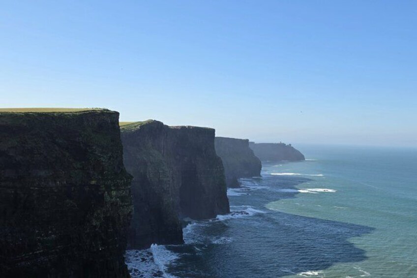 A coastal cliff with a clear view of the ocean. 1