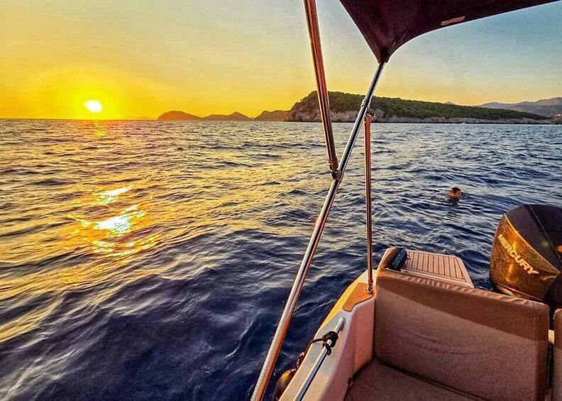 A boat's interior with a view of the sunset over the water. 4