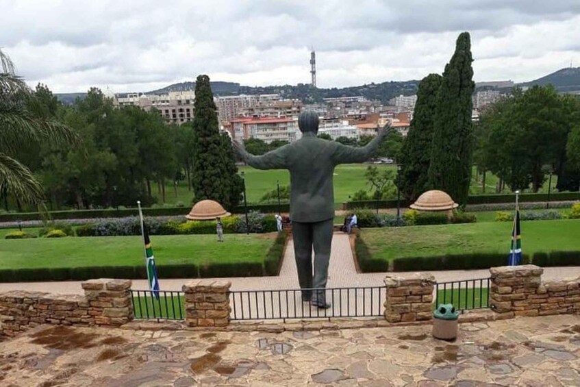 A statue of a man with outstretched arms overlooking a cityscape. 4