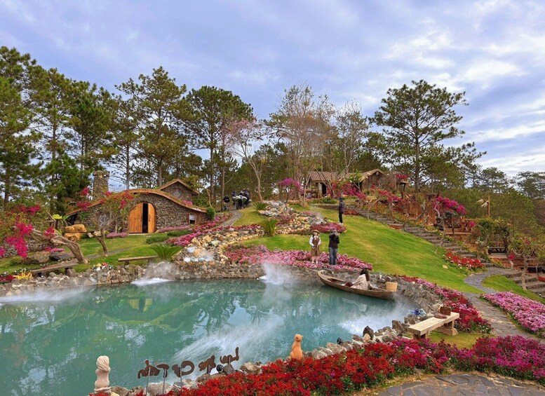 A rustic garden with a pond, stone structures, and vibrant flowers. 3