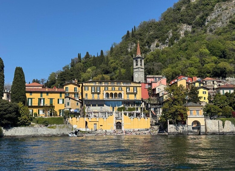 A coastal town with colorful buildings, a prominent clock tower, and a river. 4