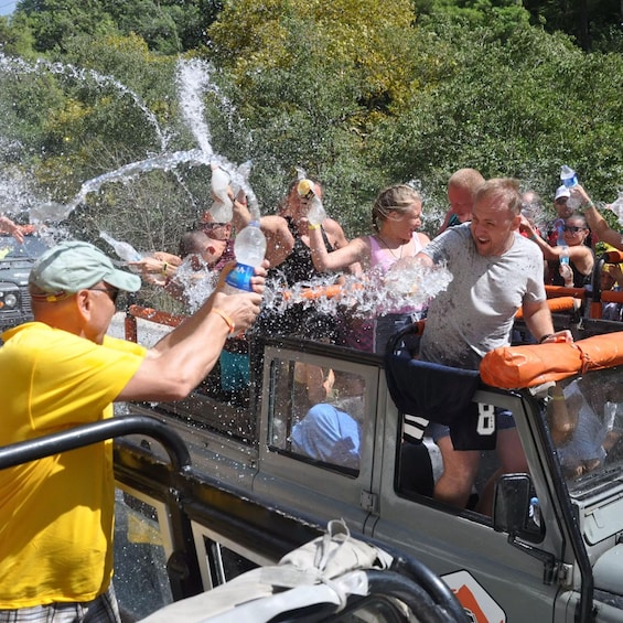 People being sprayed with water from a vehicle. 4