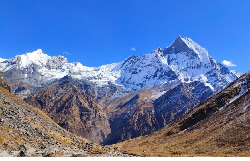 A snow-capped mountain range with clear blue skies. 4