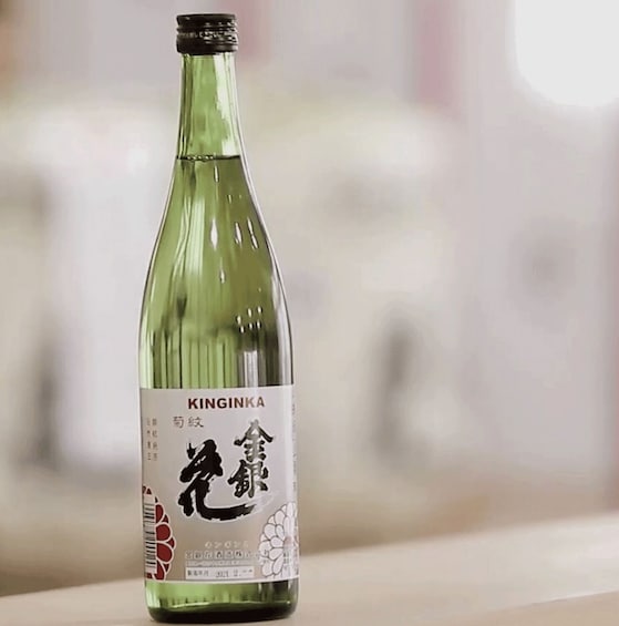 A bottle of Kinginka with a label featuring Chinese characters and a floral design. 4