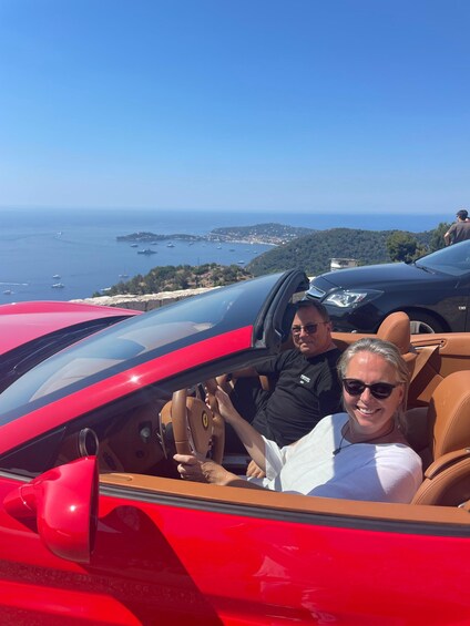 A red convertible with a scenic coastal view. 2