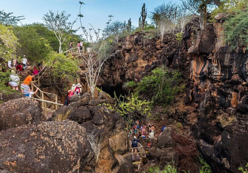 A rocky terrain with people hiking and climbing. 2