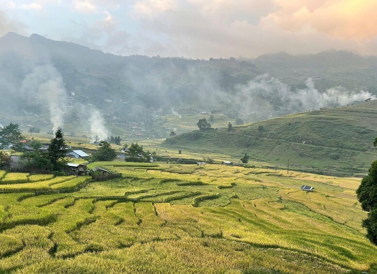 Terraced rice fields, a small village, and a mountain range. 3
