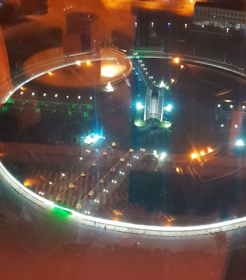 A roundabout with a central monument and surrounding streetlights. 4