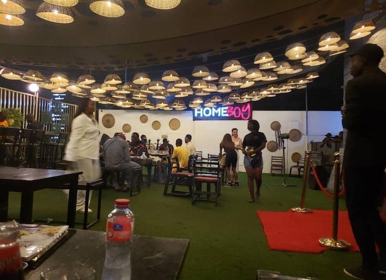 A restaurant with tables, chairs, and a red carpet event area. 3