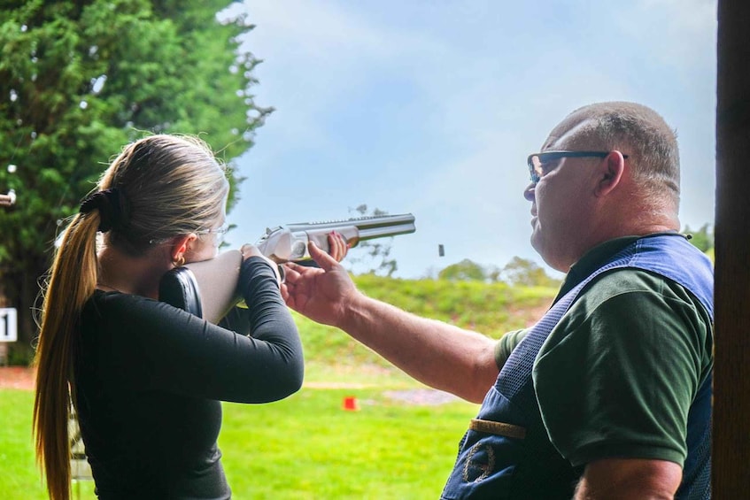 A person aiming a handgun at a target. 1