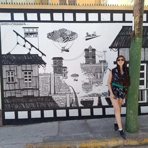 A mural with buildings, a house, a boat, and a hot air balloon. 3