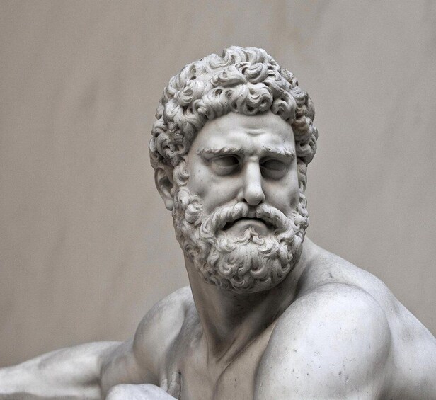 A marble sculpture of a bearded man with curly hair. 1