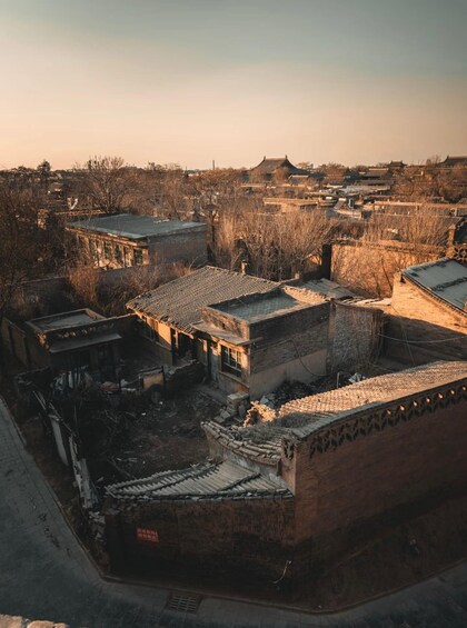 An aerial view of a traditional village with old buildings and a clear sky. 2