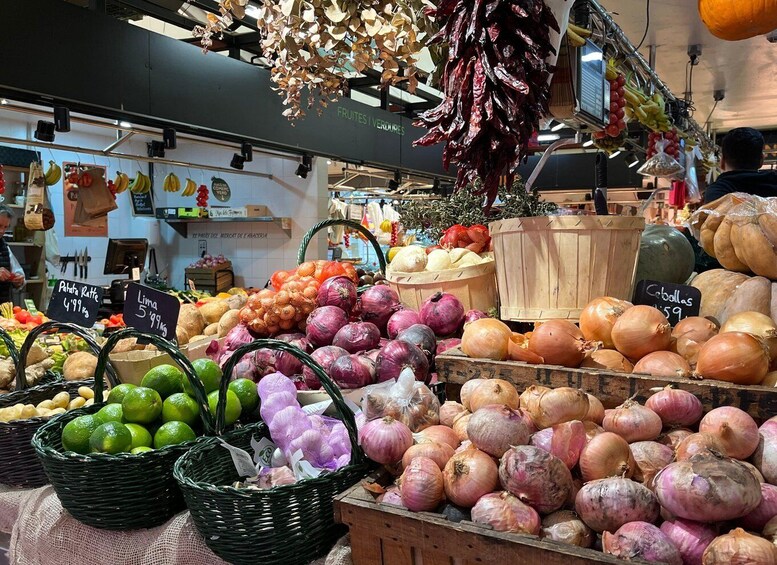 A market stall with onions, limes, and other produce. 4