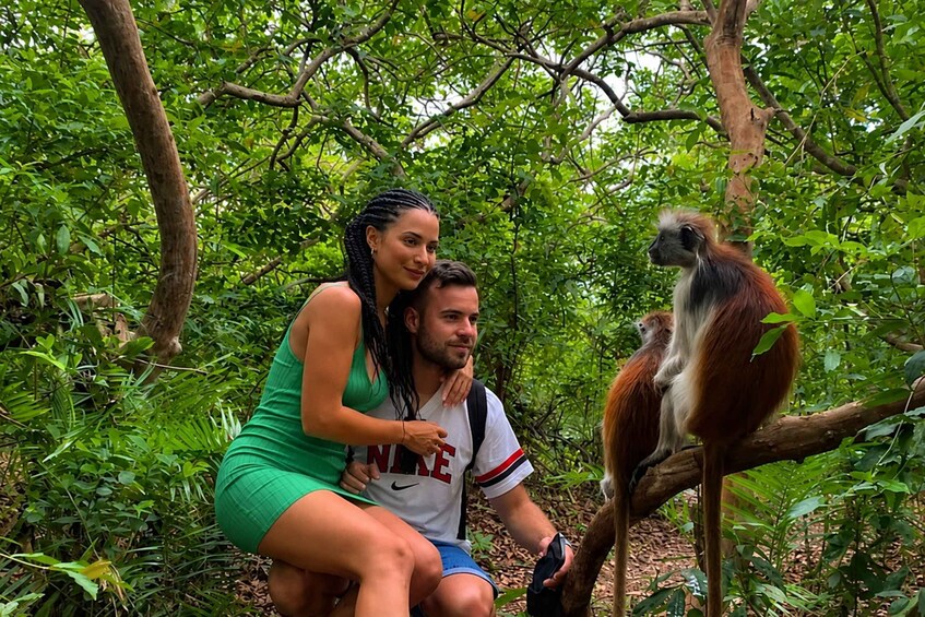 A couple in a forest with a monkey. 4