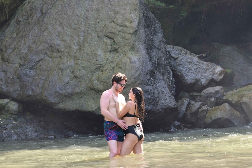 A couple in a river with a rocky background. 5