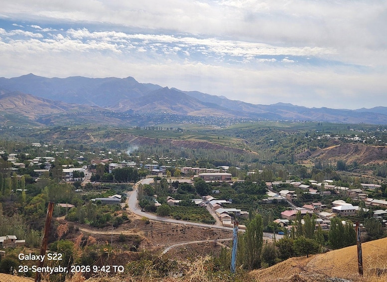 A mountainous landscape with a town nestled in the valley. 4