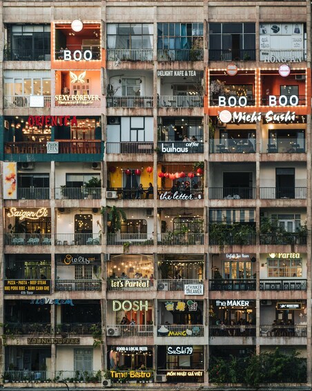 A multi-story building with various businesses including a coffee shop, a sushi restaurant, and a tea house. 3