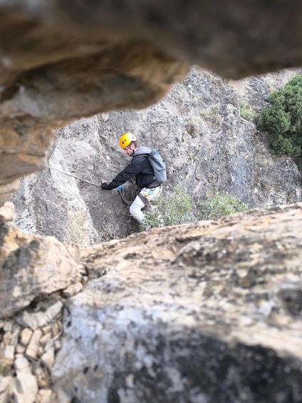 A person climbing a rocky mountain slope. 2
