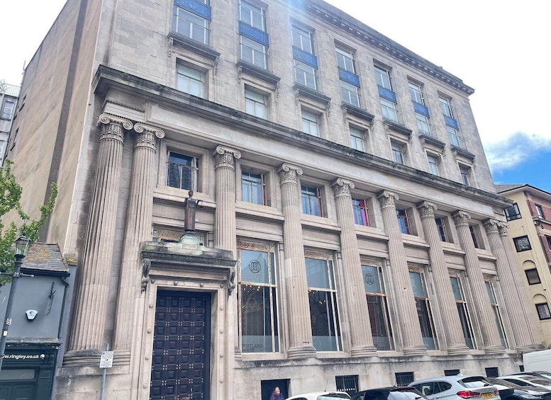 A historic building with classical architecture, featuring tall columns and large windows. 4