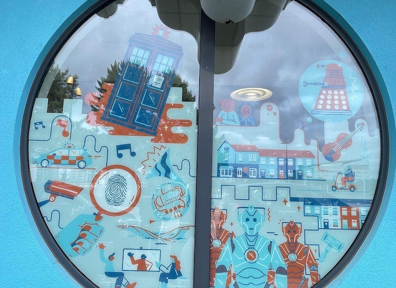 A round window with a collage of various illustrations including a blue telephone booth, a robot, and a cityscape. 3