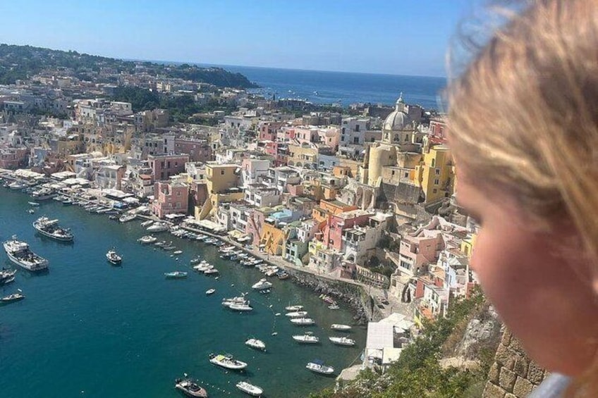 A coastal town with colorful buildings, boats in the water, and a clear sky. 2
