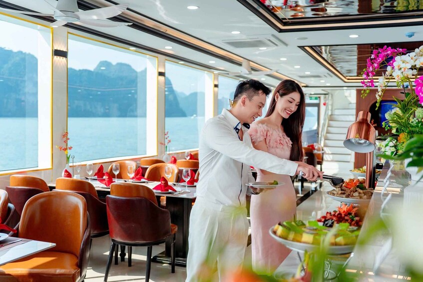 A couple dining on a cruise ship with a view of the sea and mountains. 5