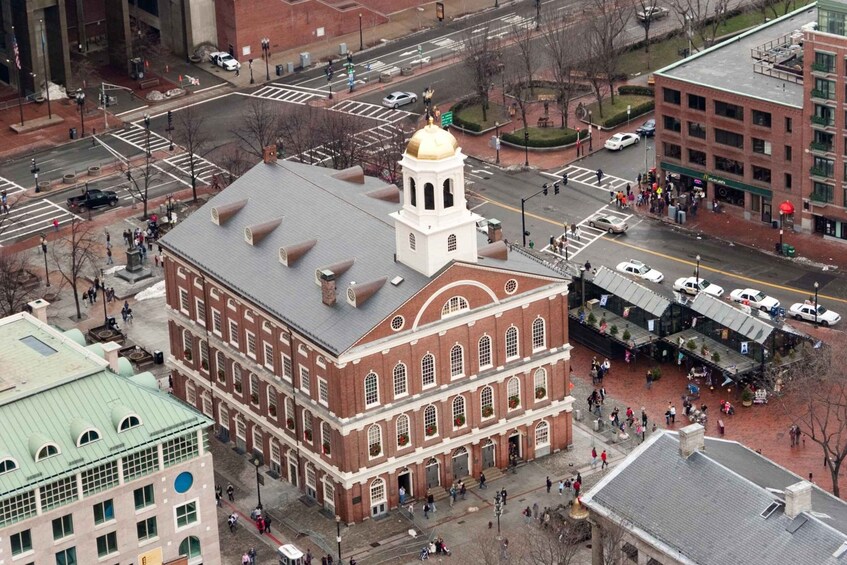 A historic building with a prominent tower and dome, surrounded by a busy urban street with pedestrians and vehicles. 5
