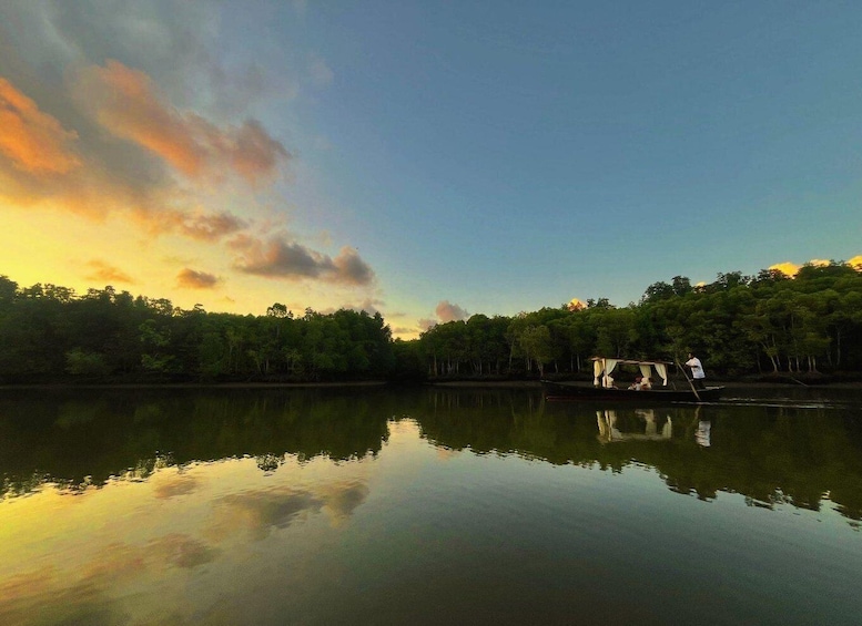 A calm river reflecting the sky, surrounded by dense forest. 3