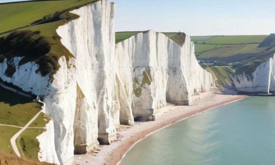 A coastal landscape with white cliffs and a sandy beach. 4