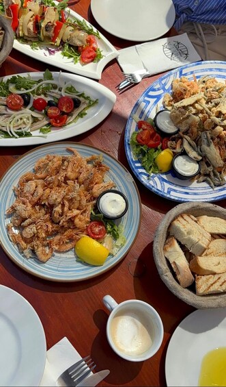A table with various dishes including seafood, salads, and bread. 4