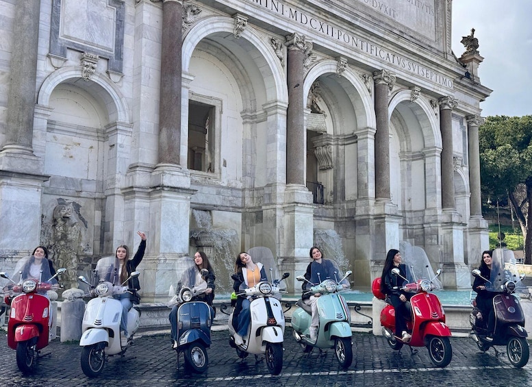 A group of people on scooters in front of a classical building with inscriptions. 3