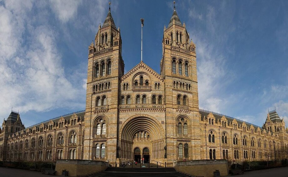 A large, ornate building with two prominent towers and a central archway. 1