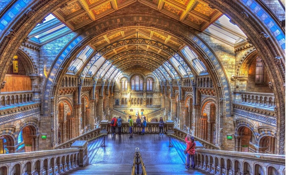 An ornate cathedral interior with a high vaulted ceiling and arched windows. 3