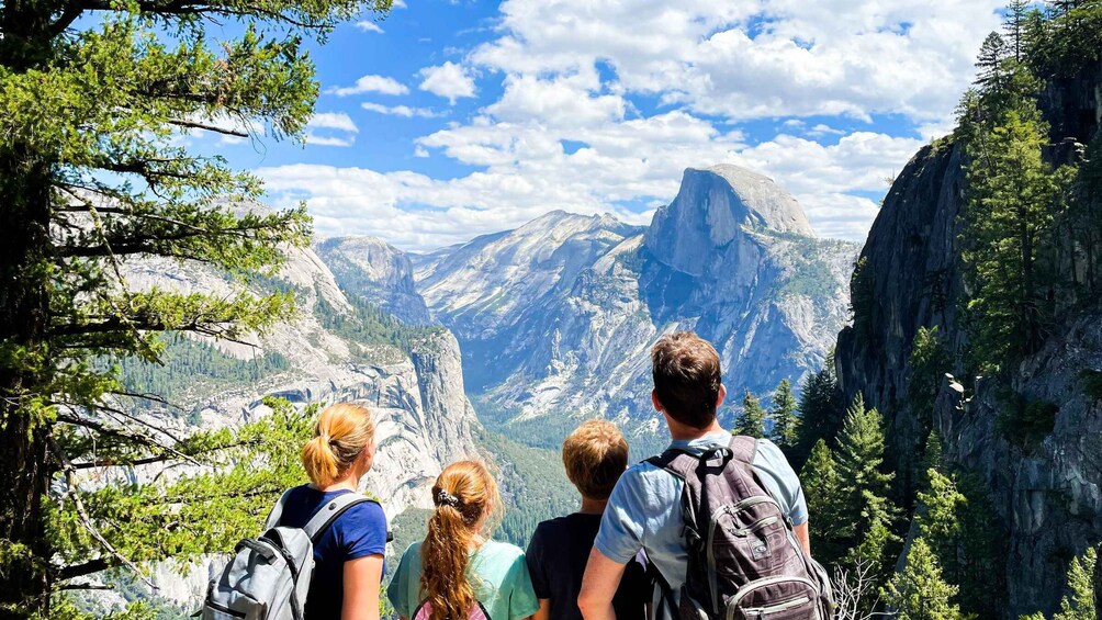 A group of hikers overlooking a mountainous landscape with prominent rock formations. 1