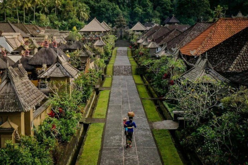 A traditional village with thatched-roof houses and a central pathway. 1
