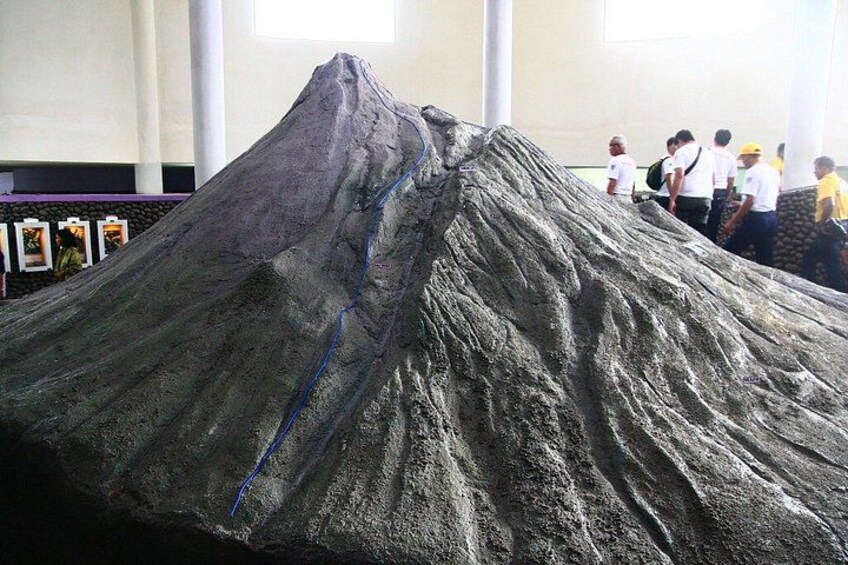 A large volcanic model with a blue line marking a path. 3