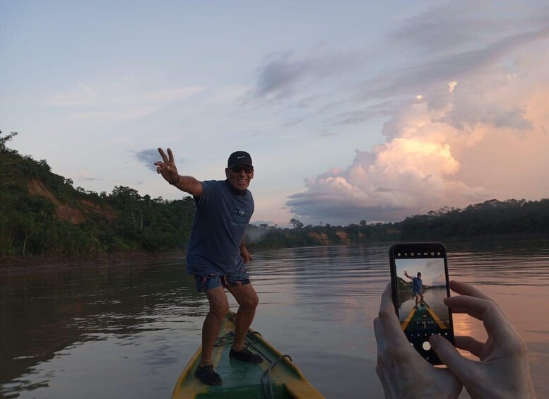 A person in a kayak on a river with a smartphone capturing the scene. 4