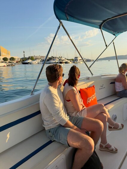 A couple on a boat with a marina in the background. 5