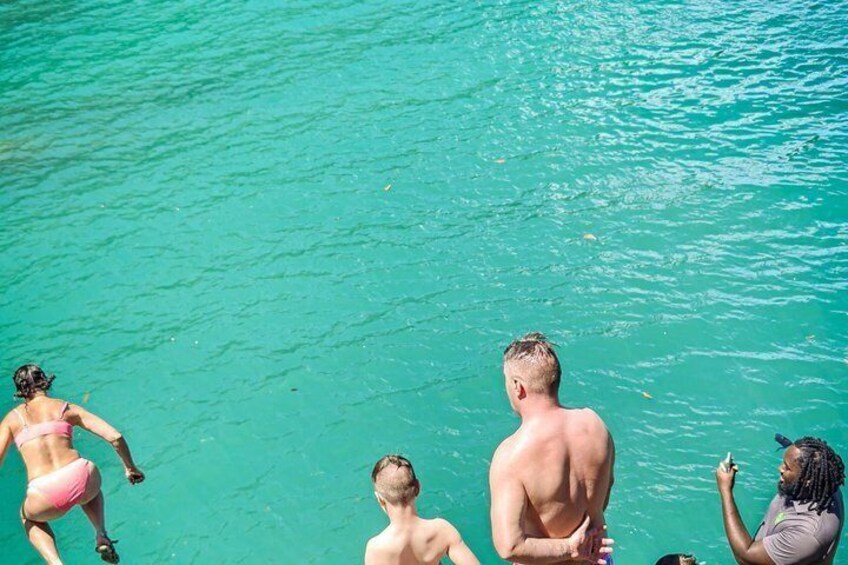 A group of people swimming in clear turquoise water. 1