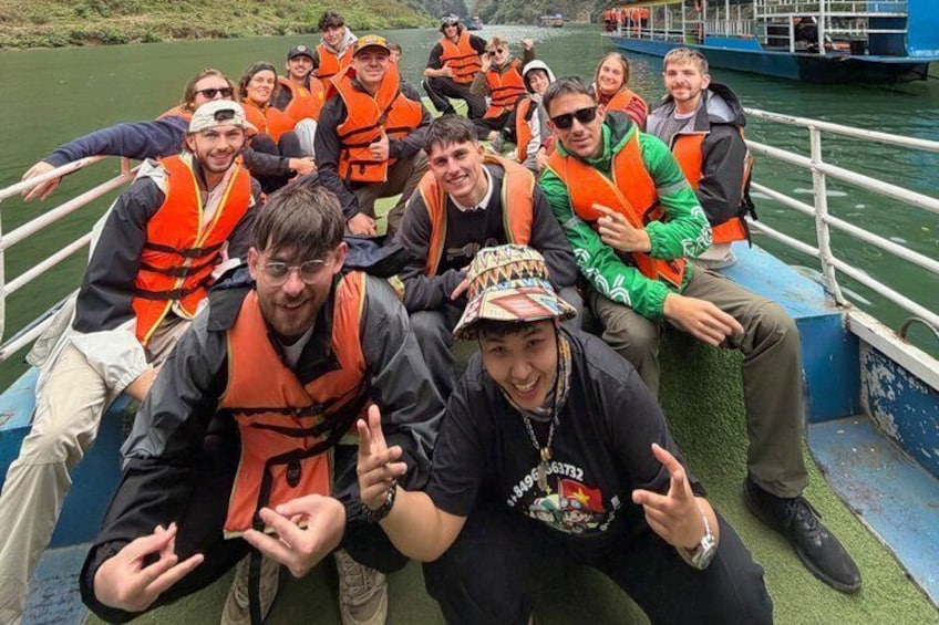 A group of people on a boat wearing life jackets. 1