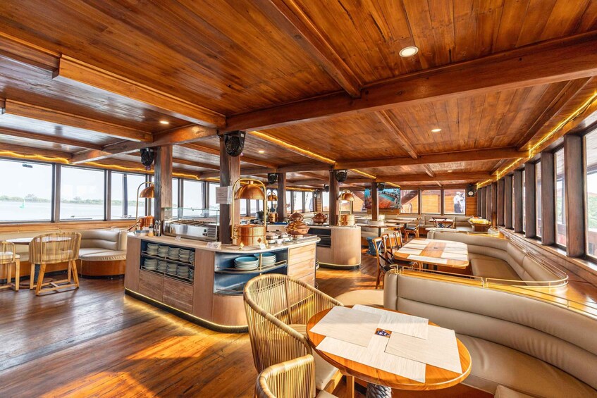 A wooden interior with a bar area, seating, and large windows. 3