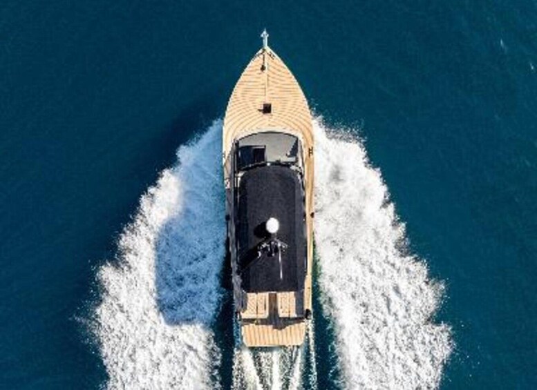 A high-speed boat creating a large wake in the ocean. 2