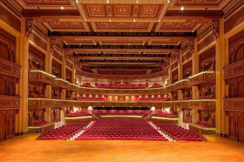 An ornate theater with red seats and intricate woodwork. 4